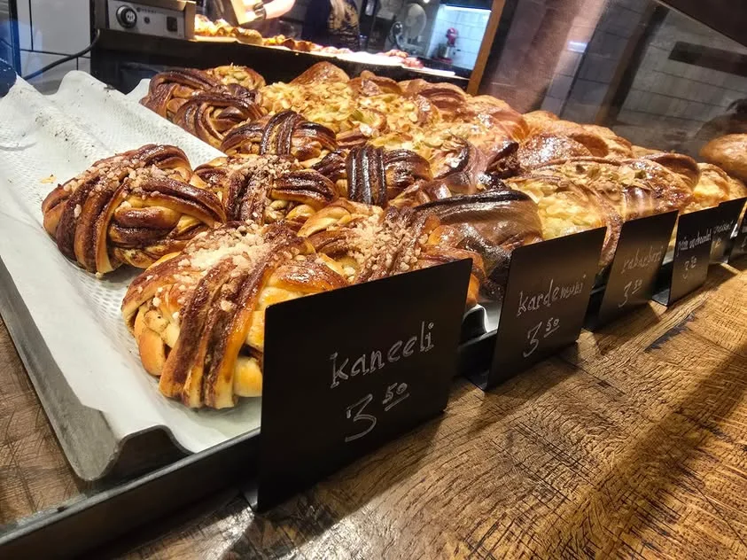 Knotted pastries sit behind chalk labels for cinnamon and cardamom.