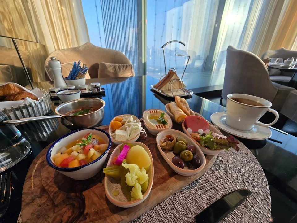 A breakfast table at Il Galante holds fruit, olives, cheese, pastries, toast and coffee.