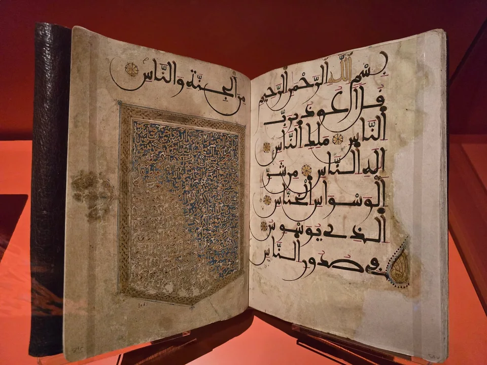 An open manuscript combines a dense blue-and-gold panel with large Arabic calligraphy on the facing page.